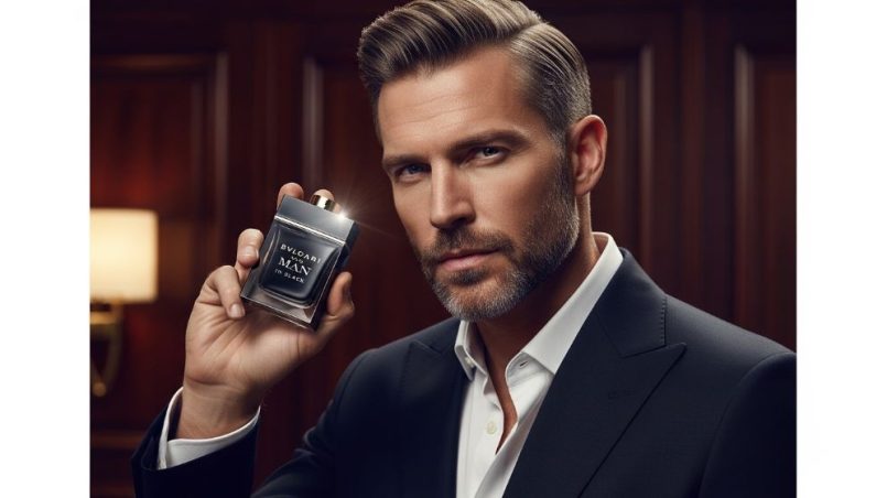 A man holding a bottle of Bvlgari Man in Black perfume against a dark, elegant background